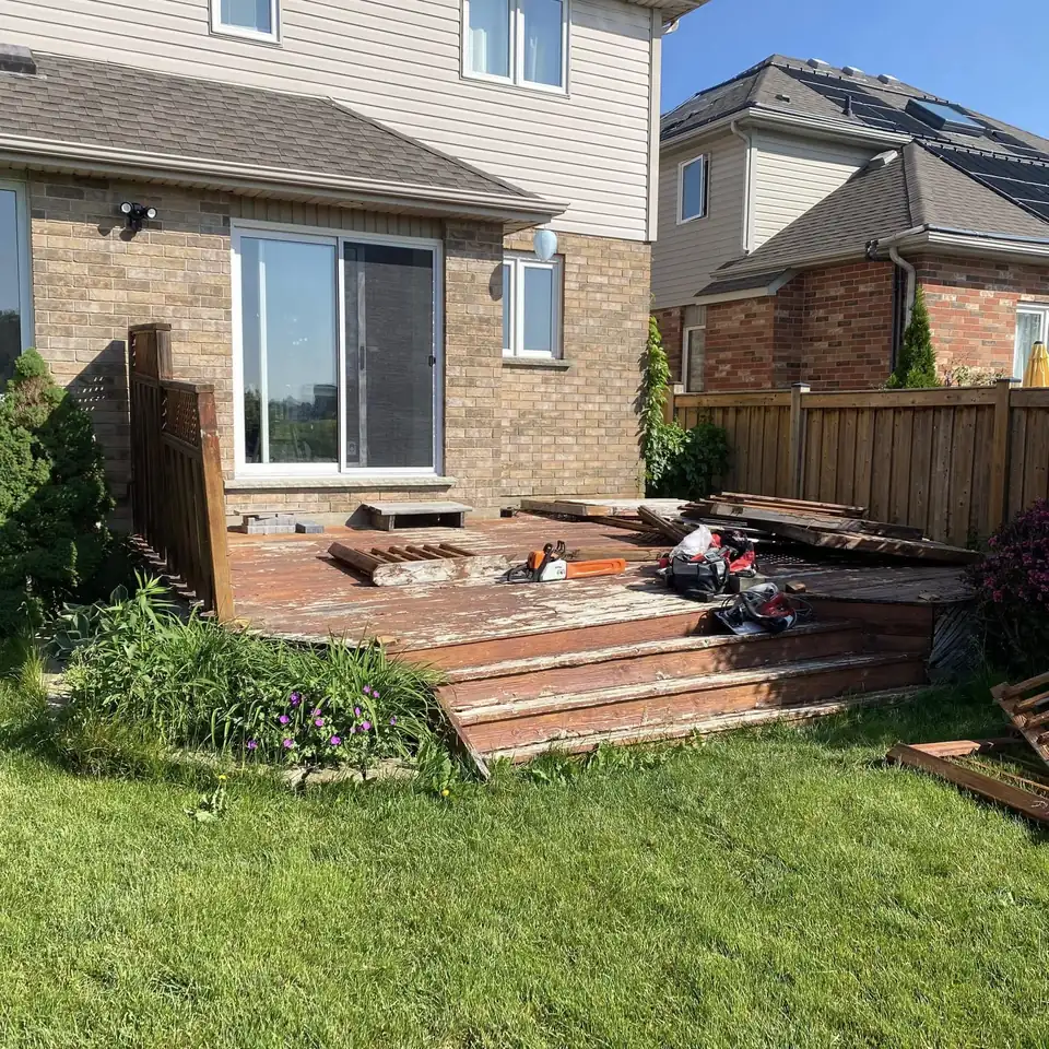Before: old wooden deck being removed from the back of the house