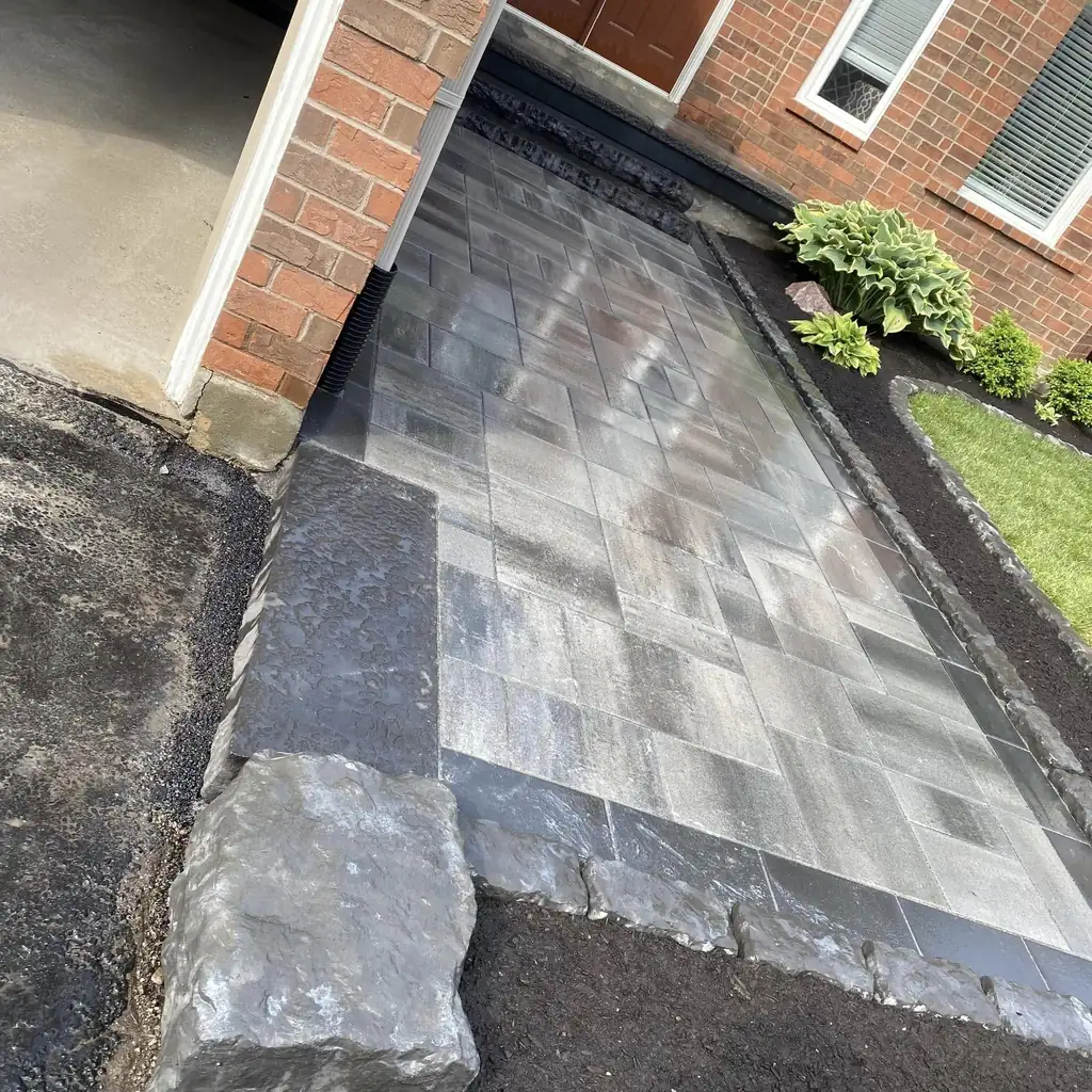 Front walkway with armour stone edging and fresh garden beds